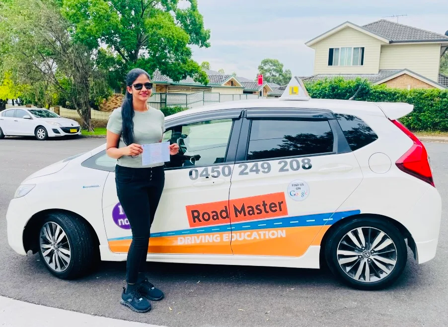 Female student in sunglasses with certificate on residential street